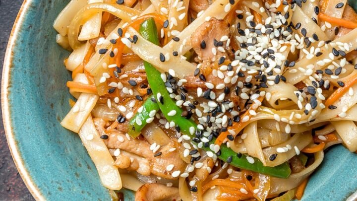 tahini noodles in a blue bowl