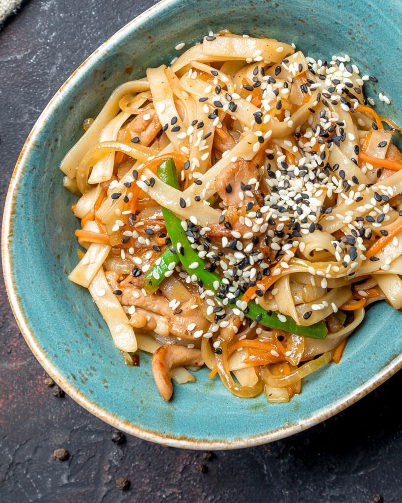 tahini noodles in a blue bowl